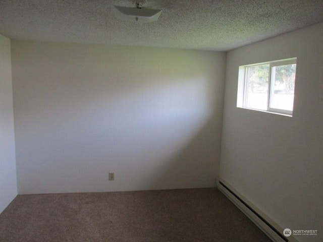 carpeted spare room with a baseboard radiator and a textured ceiling