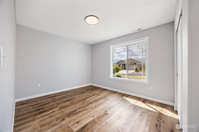 unfurnished bedroom with wood-type flooring