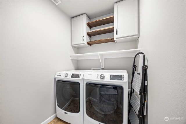 laundry area featuring cabinets and washer and clothes dryer