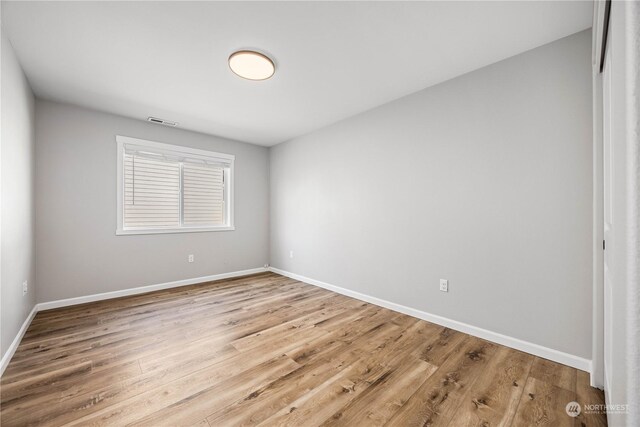 unfurnished room with light wood-type flooring