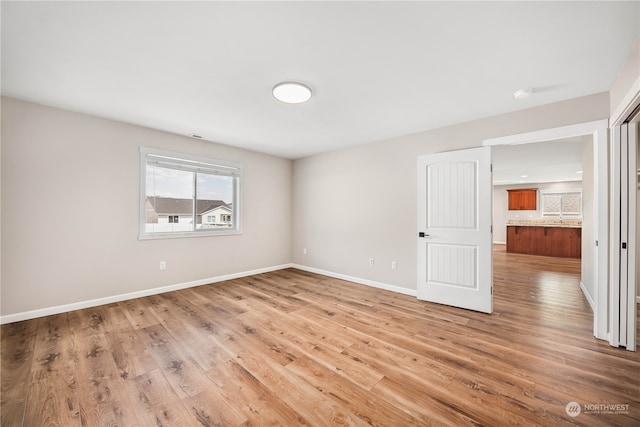 unfurnished room with wood-type flooring