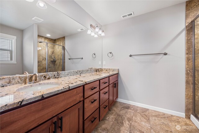 bathroom featuring an enclosed shower and vanity