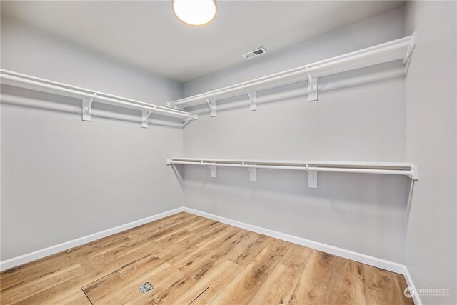 spacious closet featuring hardwood / wood-style floors