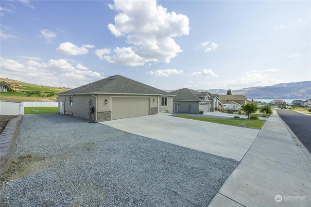 single story home with a garage and a mountain view