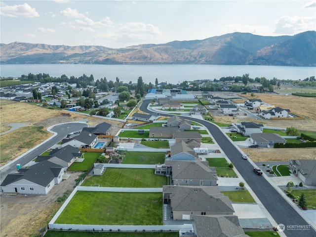 aerial view featuring a water and mountain view