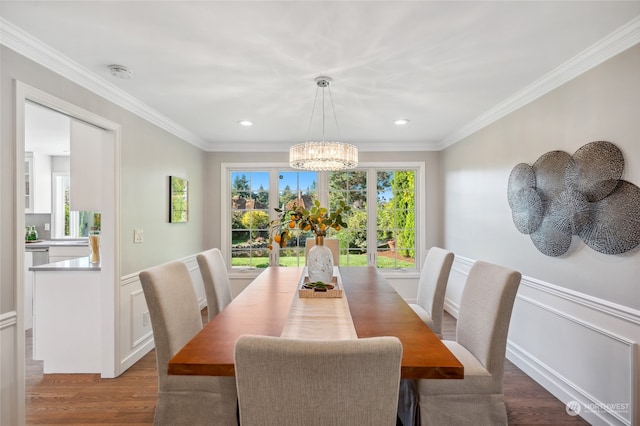 dining room with crown molding, a healthy amount of sunlight, and hardwood / wood-style floors