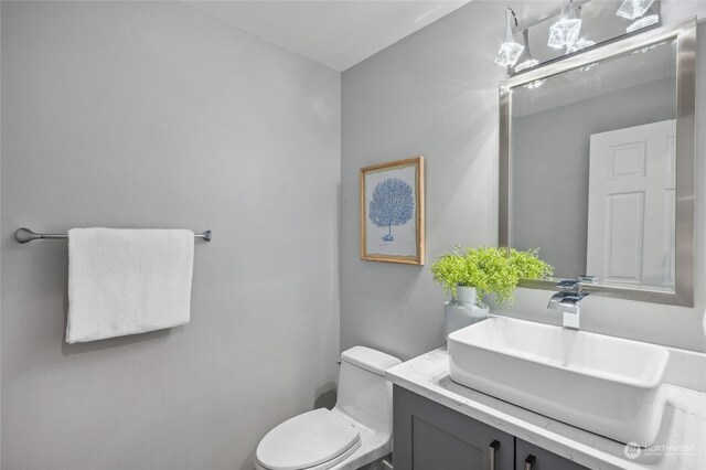 bathroom featuring toilet and vanity