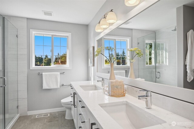 bathroom with a shower with door, vanity, and toilet