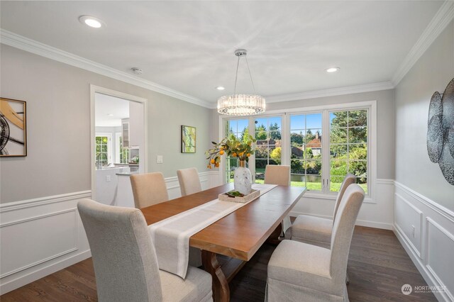 dining room featuring dark hardwood / wood-style floors, a chandelier, and crown molding