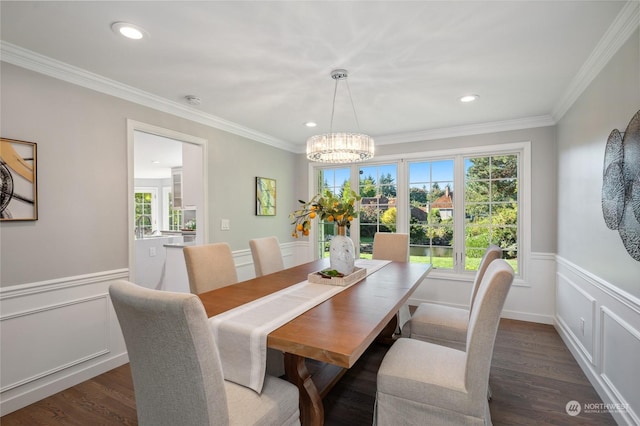 dining space with a wainscoted wall, dark wood finished floors, and crown molding