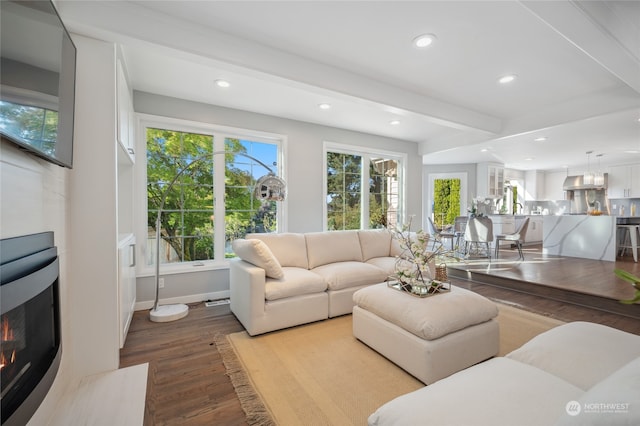 living room with hardwood / wood-style floors and beam ceiling