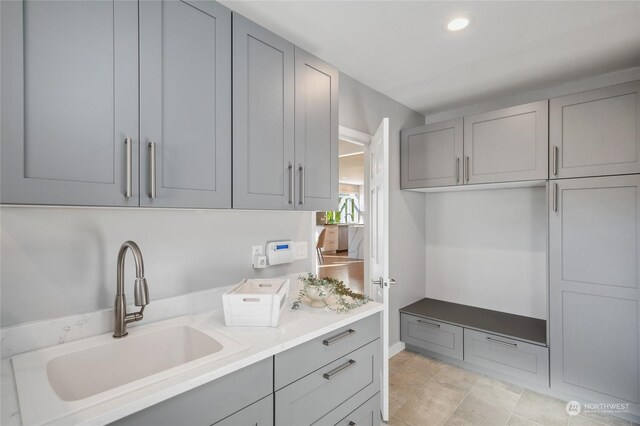 clothes washing area featuring sink