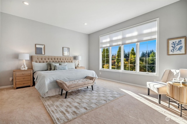 carpeted bedroom featuring baseboards and recessed lighting