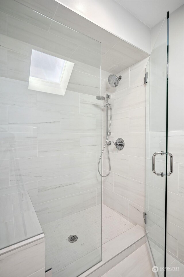 bathroom featuring a shower with door