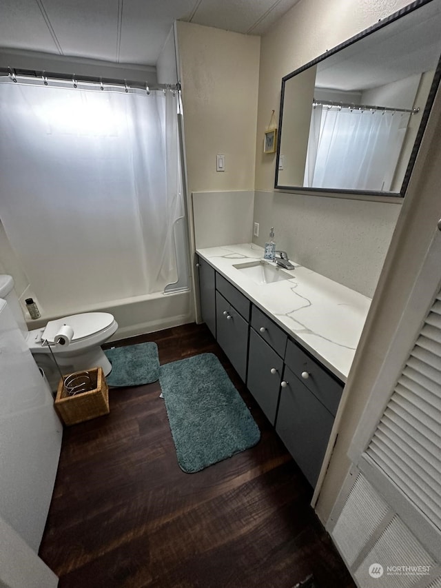 full bathroom featuring vanity, toilet, hardwood / wood-style floors, and shower / bath combo with shower curtain