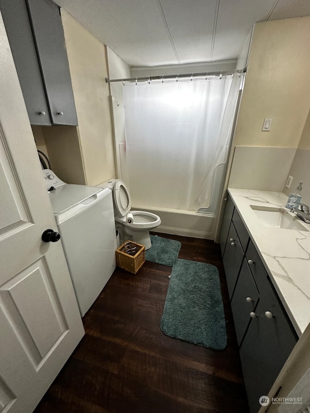 full bathroom featuring hardwood / wood-style flooring, shower / bathtub combination with curtain, toilet, washer / clothes dryer, and vanity