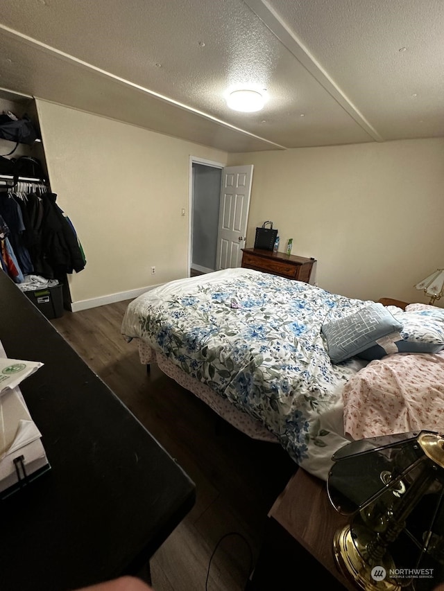 bedroom featuring hardwood / wood-style floors and a textured ceiling