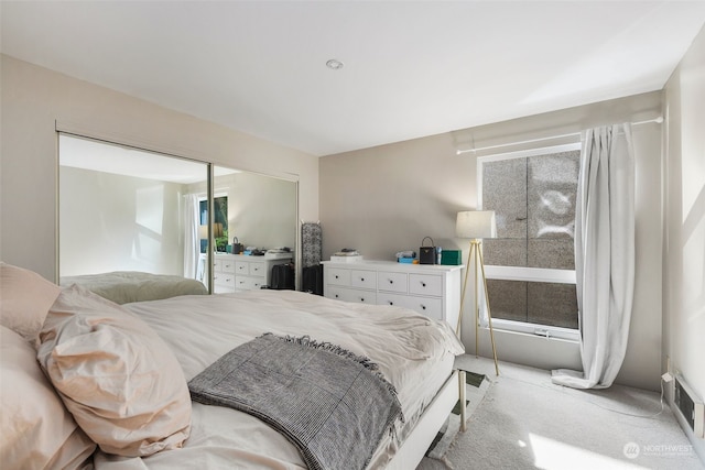 bedroom with a closet and light carpet