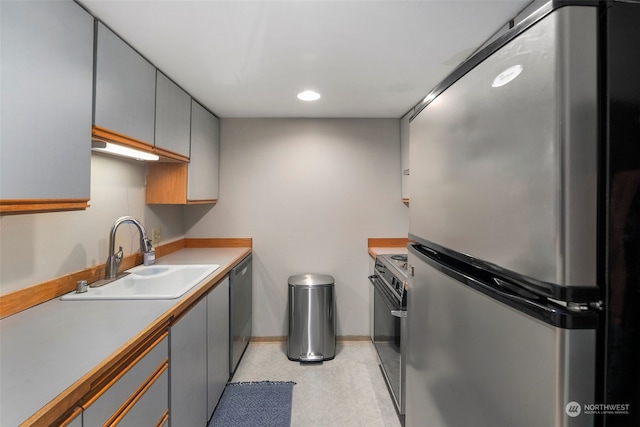 kitchen with sink, gray cabinets, and appliances with stainless steel finishes