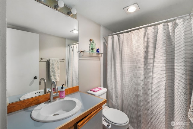 bathroom featuring vanity, toilet, and a shower with shower curtain