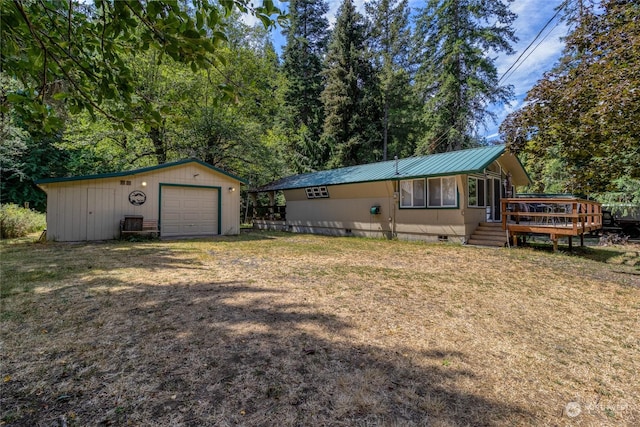 view of front of property with a detached garage, dirt driveway, crawl space, metal roof, and an outdoor structure