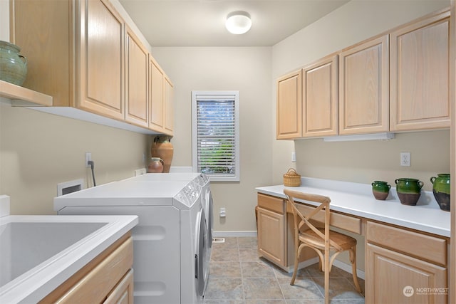 washroom featuring light tile patterned flooring, cabinets, independent washer and dryer, and sink