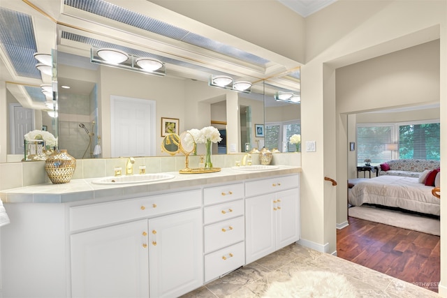 bathroom with vanity, wood-type flooring, ornamental molding, and walk in shower