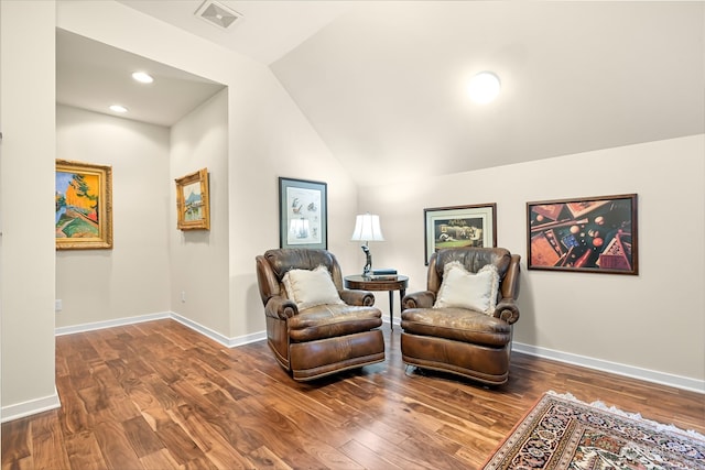 living area featuring hardwood / wood-style flooring and lofted ceiling