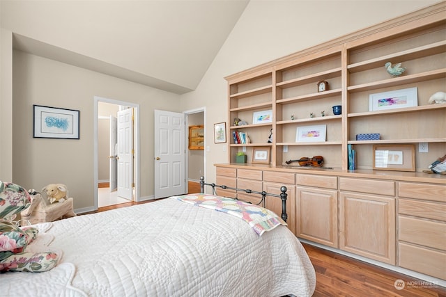 bedroom featuring light hardwood / wood-style flooring and lofted ceiling