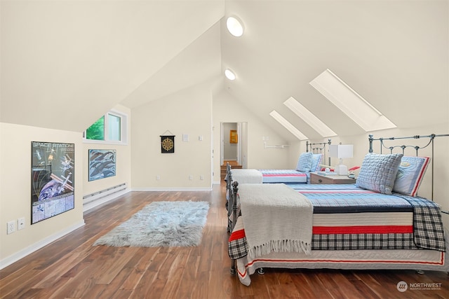 bedroom featuring hardwood / wood-style floors, lofted ceiling with skylight, and a baseboard heating unit