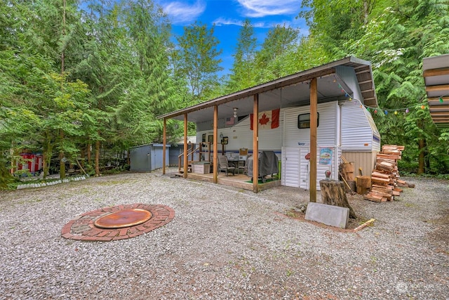 1056 Birch Ln, Sumas, WA 98266 - back of house with a storage unit, an outdoor structure, and a wooden deck