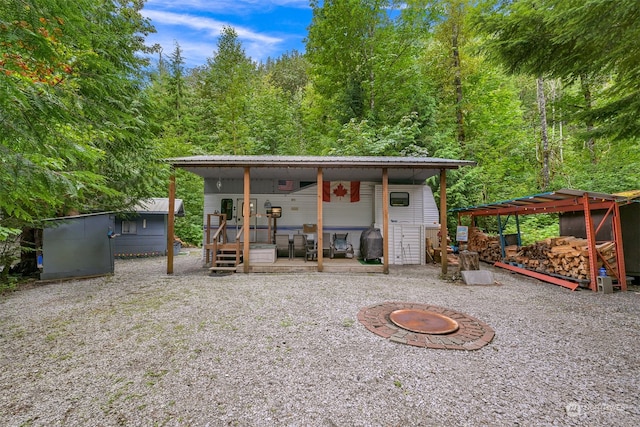 back of property featuring a patio area, an outdoor fire pit, and a pergola