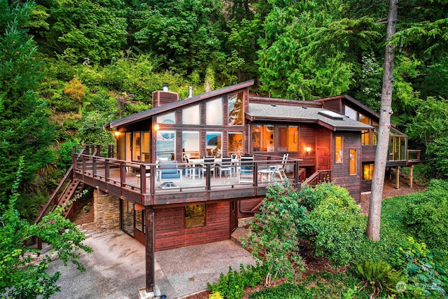 rear view of property featuring a deck