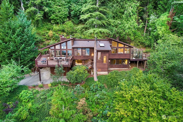 back of property featuring a patio and a deck