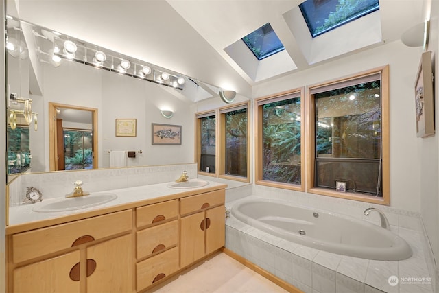 bathroom featuring dual vanity, vaulted ceiling with skylight, a relaxing tiled tub, and tile patterned flooring