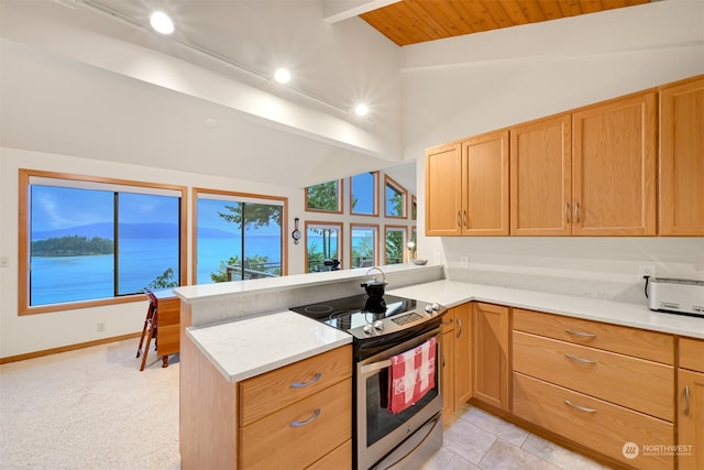 kitchen with kitchen peninsula, vaulted ceiling with beams, and stainless steel electric stove