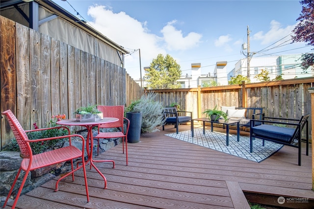 wooden terrace featuring an outdoor hangout area