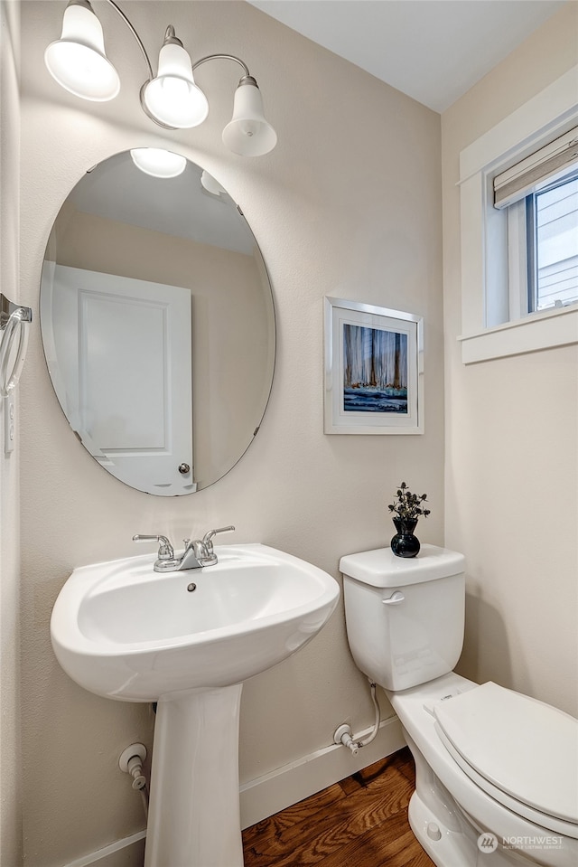 bathroom with hardwood / wood-style floors and toilet