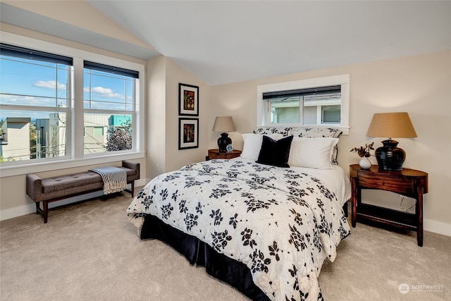 bedroom featuring light carpet and vaulted ceiling