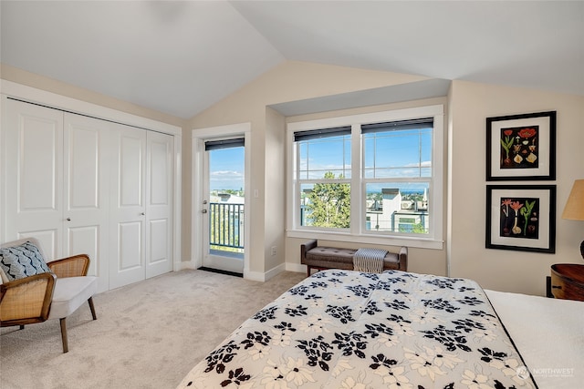 carpeted bedroom with vaulted ceiling, a closet, and access to outside