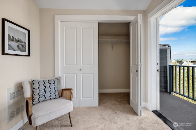 sitting room with light carpet and radiator heating unit