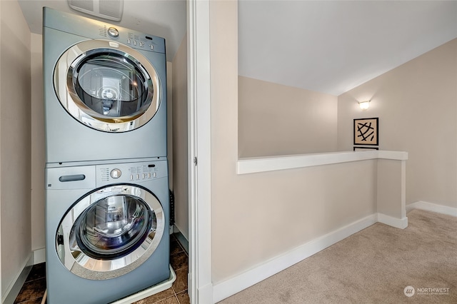 washroom with stacked washer and dryer and carpet floors