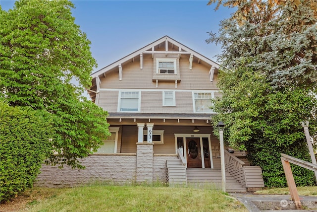 rear view of property with covered porch