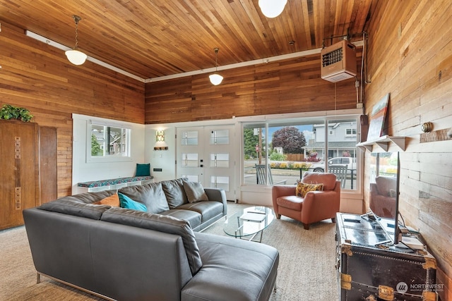 carpeted living room with a towering ceiling, wood walls, and wood ceiling