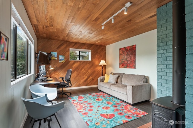 office area with wooden walls, wood finished floors, wood ceiling, and track lighting