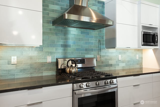 kitchen featuring wall chimney range hood, tasteful backsplash, modern cabinets, and stainless steel appliances