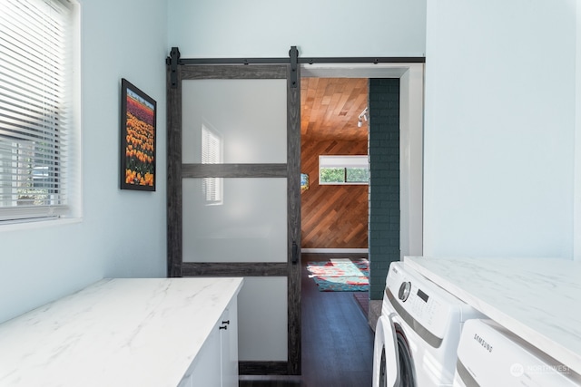 laundry area with laundry area, a barn door, and separate washer and dryer