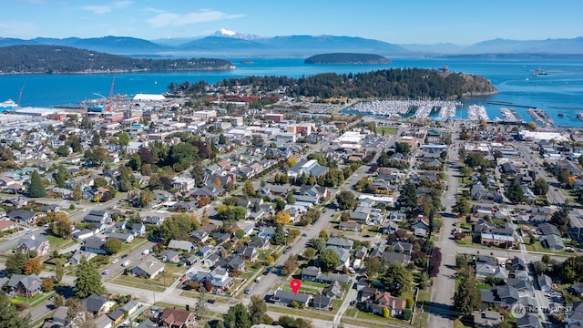 drone / aerial view featuring a water and mountain view