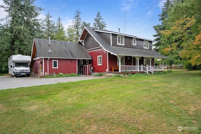 view of front of house featuring covered porch and a front yard