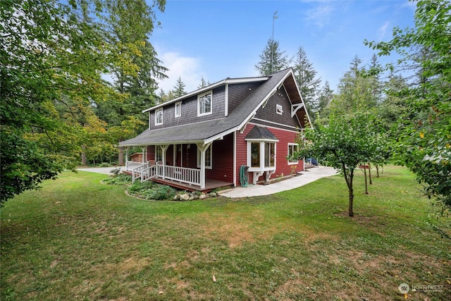 back of house with a yard and a porch